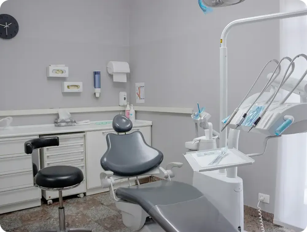 A modern dental chair with adjustable features, positioned in a well-lit dental office.