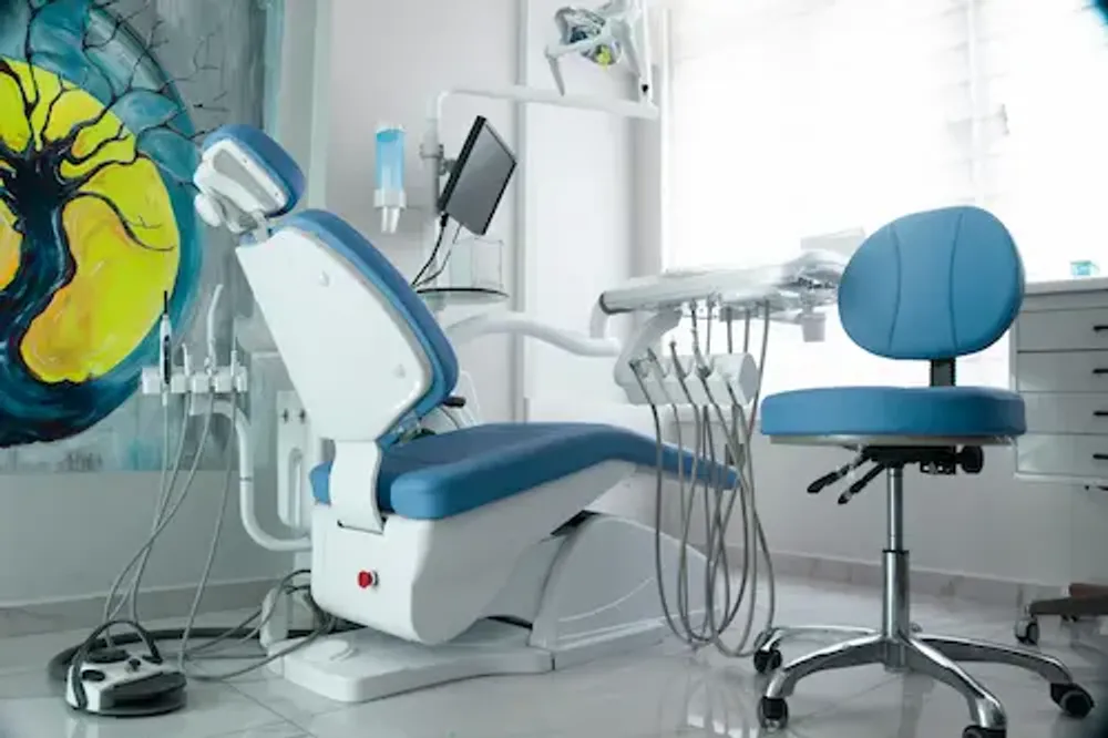 Modern dental chair with overhead light in a treatment room