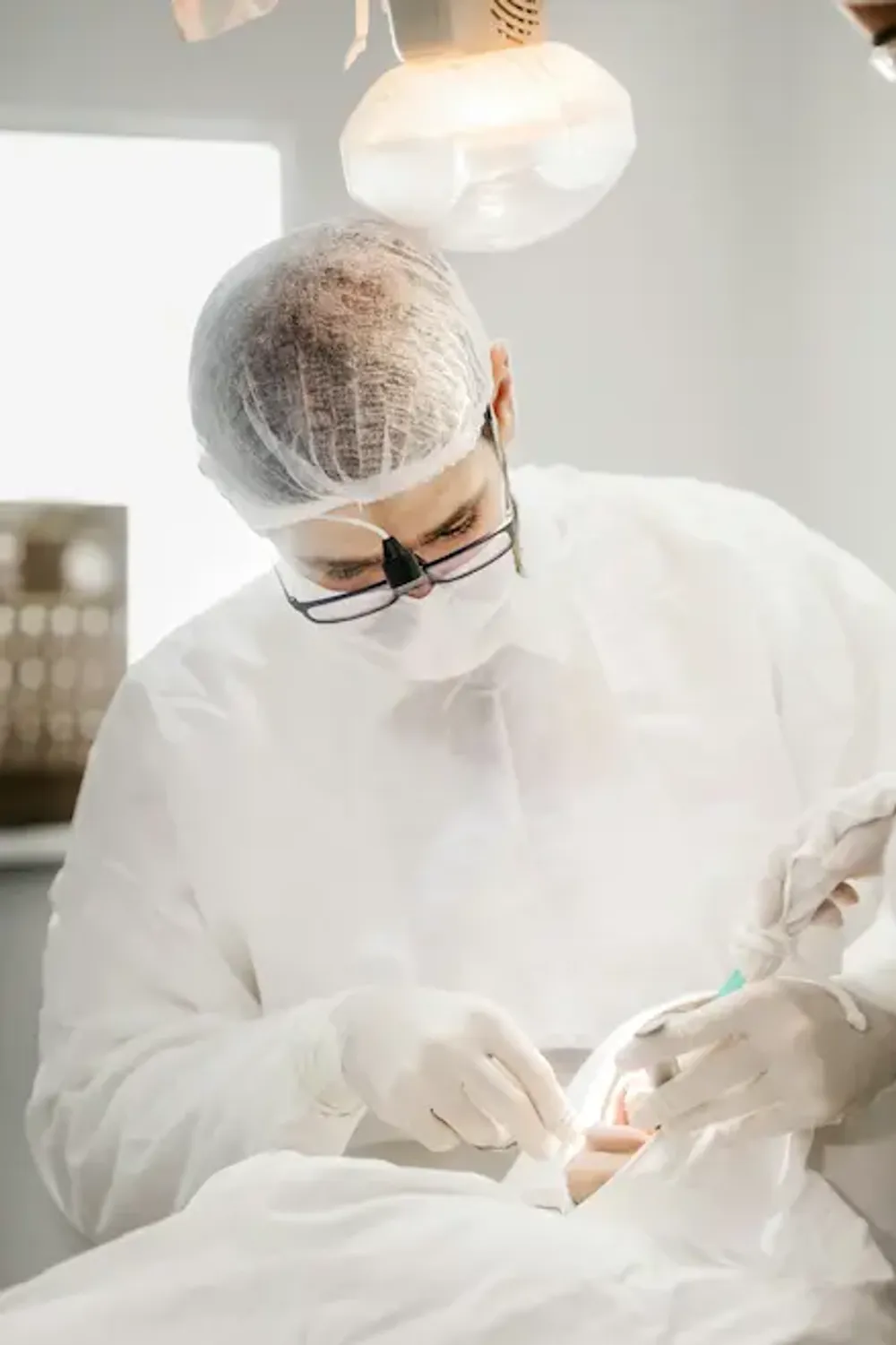 Dental professional wearing PPE conducting a treatment on a patient