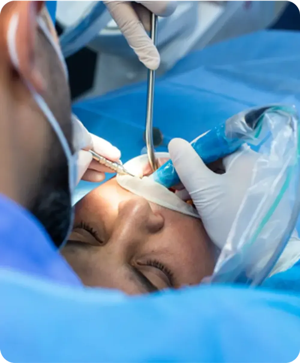 Dentist with gloves and face mask conducting a dental treatment on a woman in a clinic